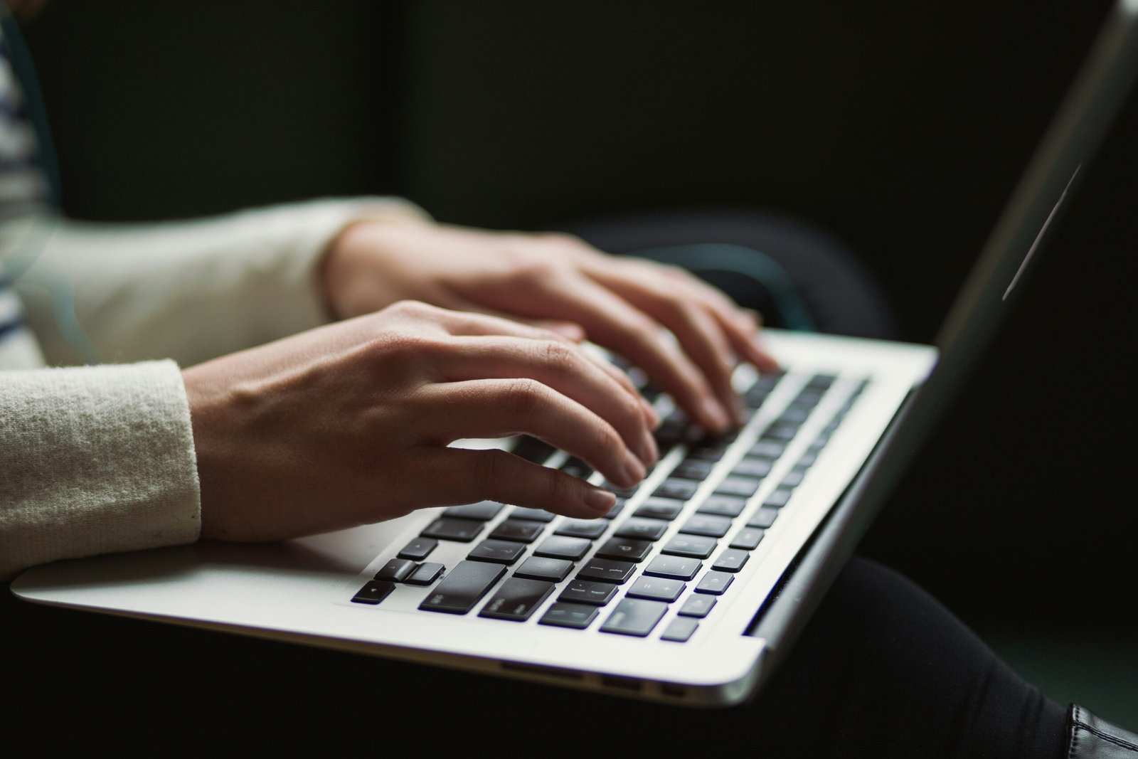 Closeup of woman typing on laptop